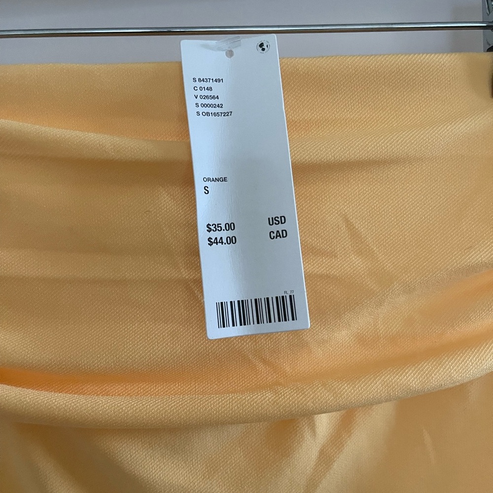 Orange asymmetrical top from Urban Outfitters, never worn. Size:S
